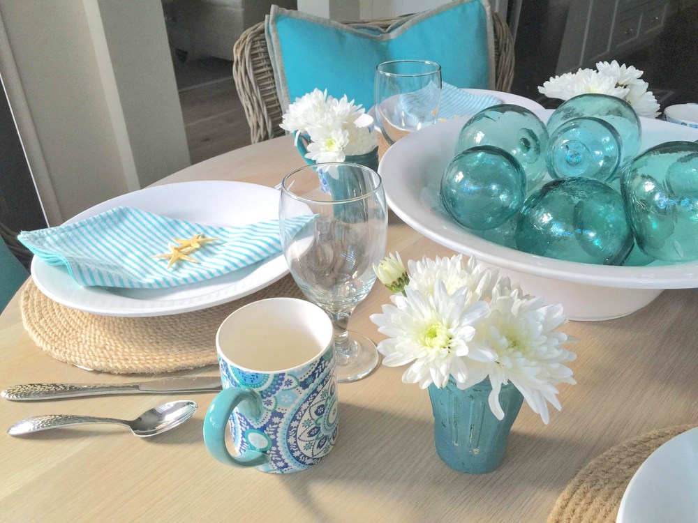 Coastal tabletop, beach inspired entertaining, turquoise and white, glass floats | Interior Designer: Carla Aston