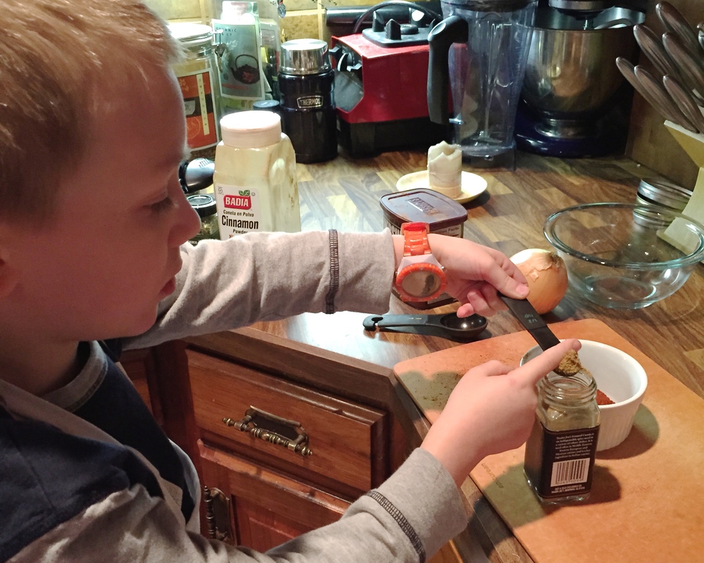 Jonathan measuring spices for Chilly Night Chili. We all loved it so much, he'll be making it for our church chili cook-off this Sunday!