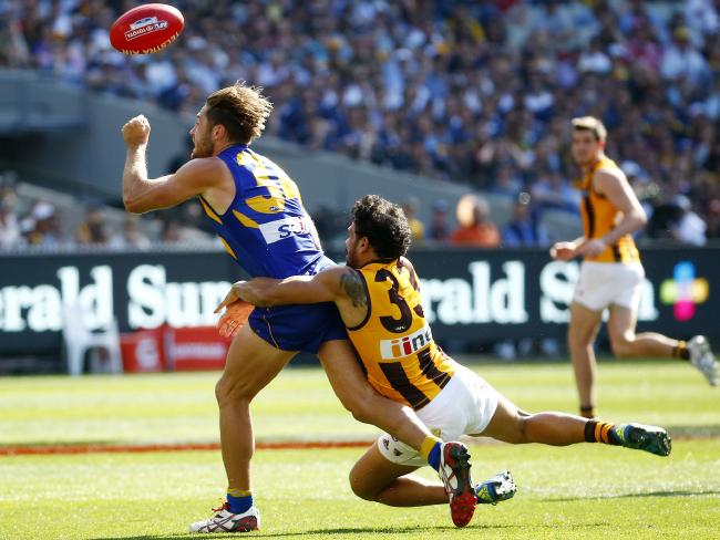 Cyril Rioli performs one of the best tackles in recent AFL history to help Hawthorn defeat West Coast in 2015 AFL Grand Final image copyright - News Corp Photographer - Colleen Petch