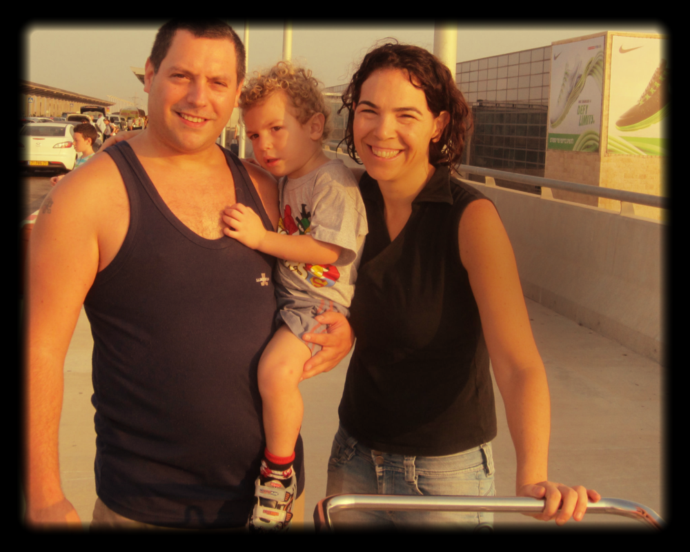 Us (my wife Tal and me, Roy) with Aviv, our middle child. Before entring the airport