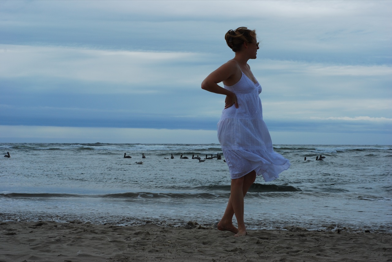woman on beach in a gauzy windblown dress