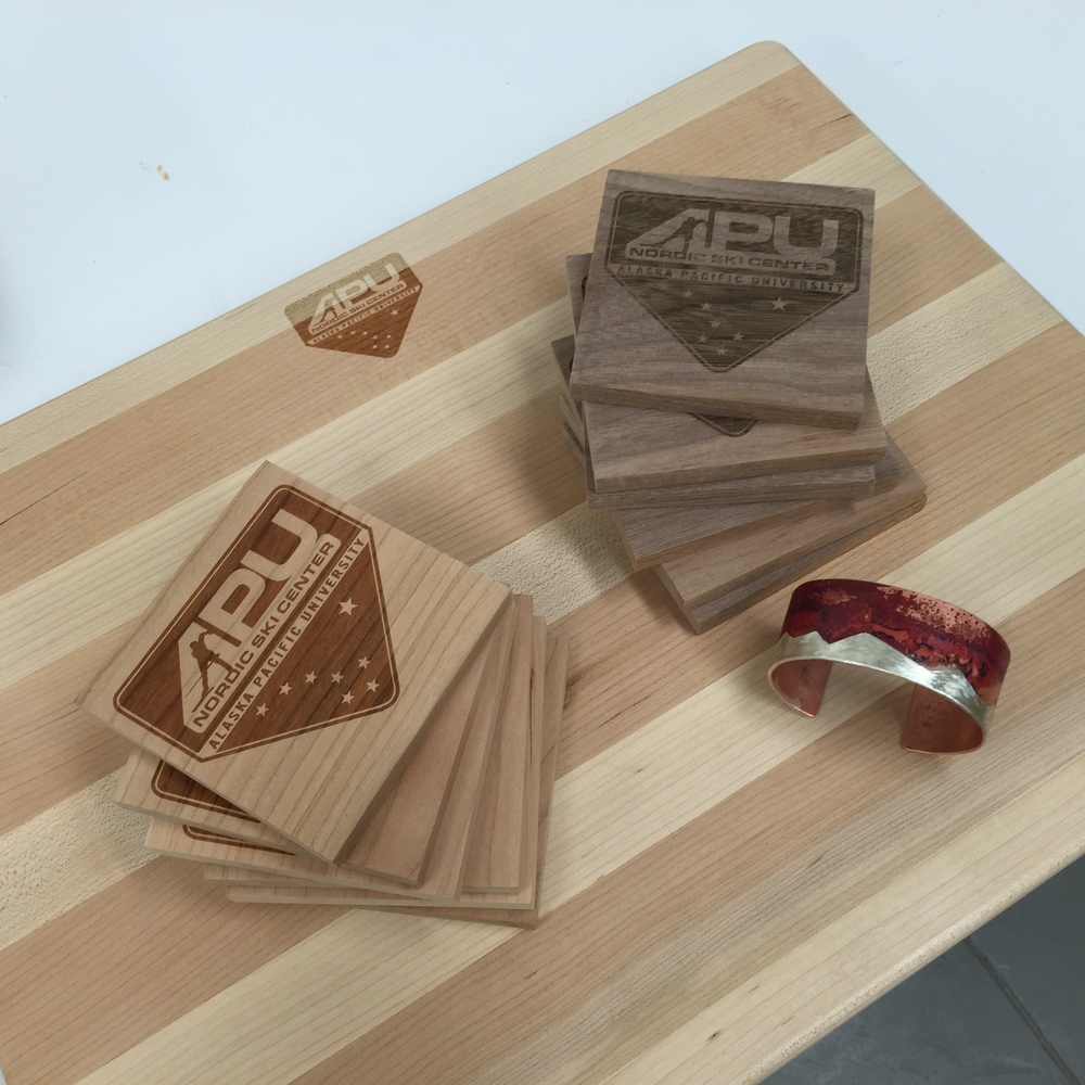 A handmade cutting board, drink coasters, and cuff bracelet.  The wood products are laser-engraved with the APUNSC logo, so they're one-of-a-kind auction items.  Make sure to check them out on May 8th at the APU Atwood building, where they will be available to bid on!  Those cuff bracelets are also definitely unique because no oxidation pattern is ever the same, so if you like it you'd better put a bid on it... just saying.