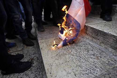 Palestinians burnÂ the French flag on the Temple Mount on FridayÂ in protest of the new cover of the French satirical magazineÂ Charlie Hebdo. Credit: Facebook.