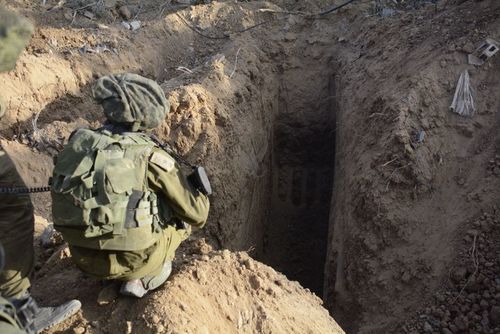 An IDF soldier overlooking an uncovered Hamas terror tunnel in the Gaza Strip during Operation Protective Edge last July. Credit: Israel Defense Forces.