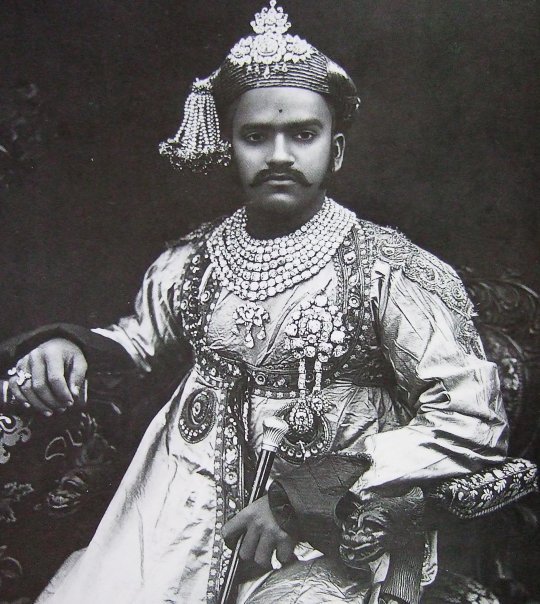 Maharaja Sayaiji-Roa, Gaekwar, Baroda. 1902. Wearing his famous seven row diamond necklace and other diamond ornaments. In the late 19th and early 20th centuries, virtually every Indian Maharaja commissioned state photographs of themselves wearing their most important jewelry as a symbol of their power and position.