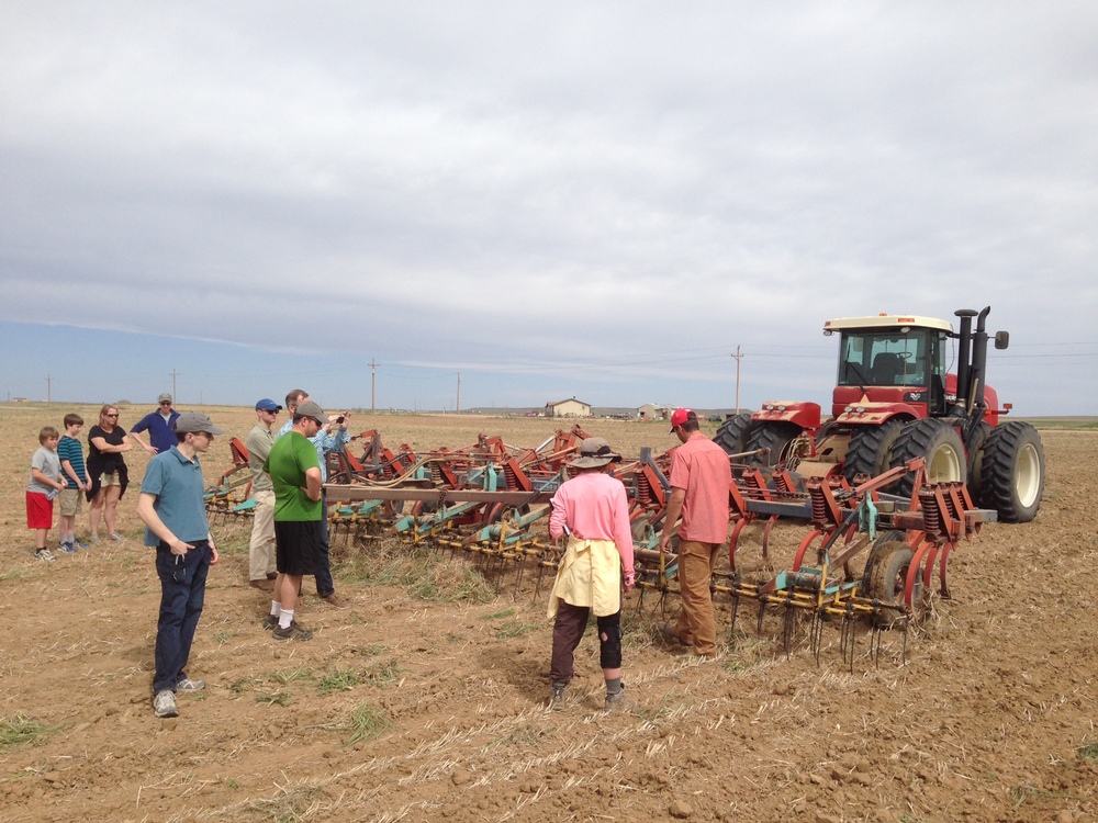 The Agribotix crew & co. admiring one of Golden Prairie's tractors.