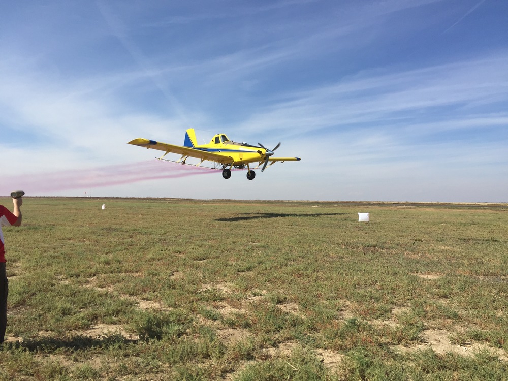   An Air Tractor spraying colored water in a demonstration.  The drone visibility tests were done at 250ft AGL.
