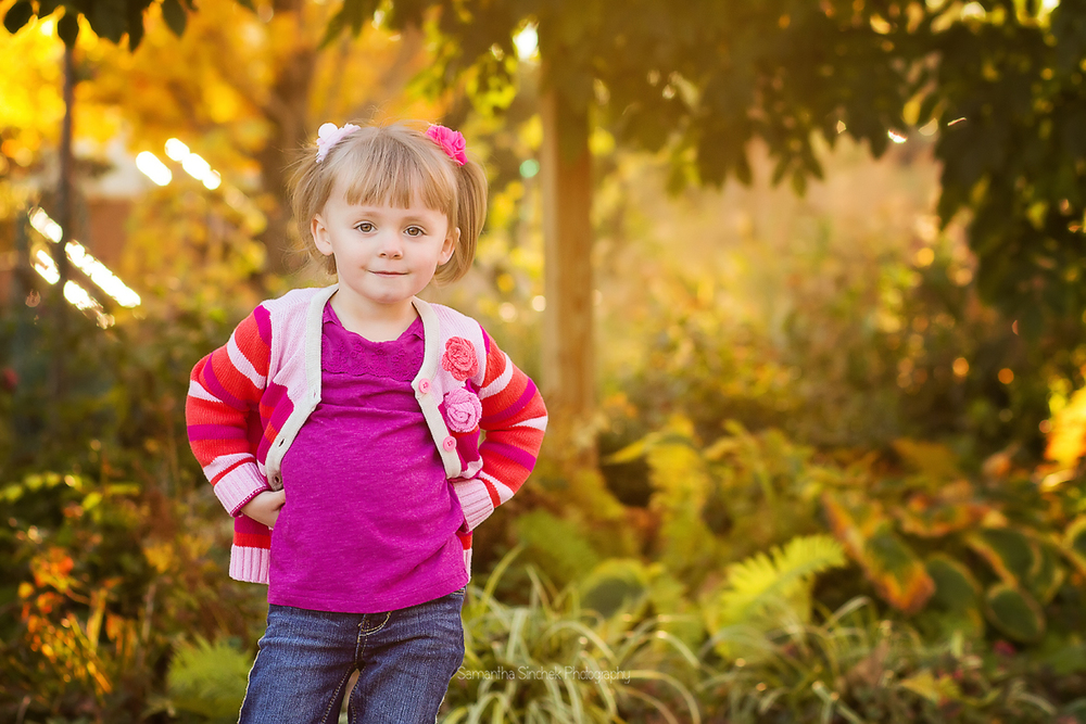Toddler girl gives the camera some sass during her family photo session with Samantha Sinchek Photography
