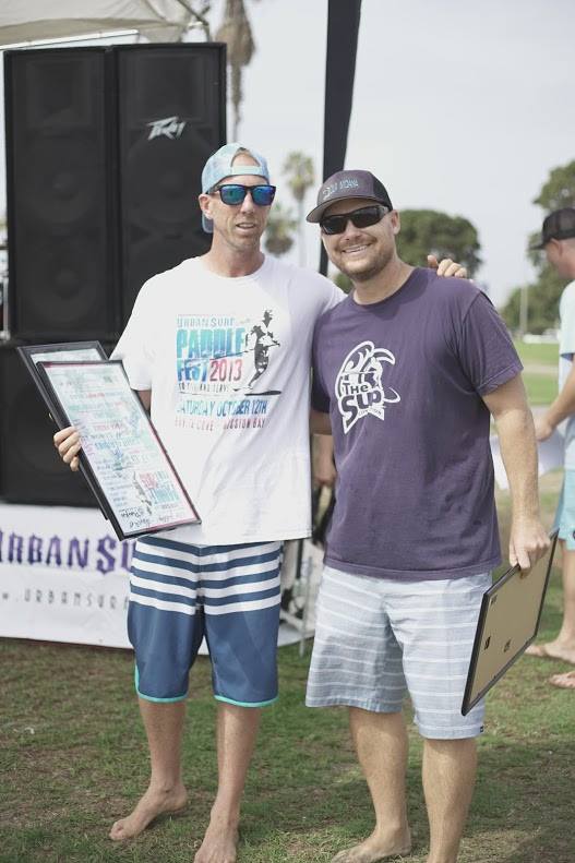 Wes giving Jeton a thank you framed and signed poster for The SUP Connections contributions to the event. 