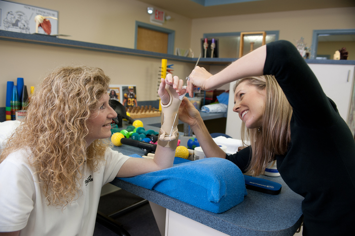 Kim Malone works with Tidewater Physical Therapy therapists at the Salisbury, Md. clinic to manage injuries to her left hand and arm.