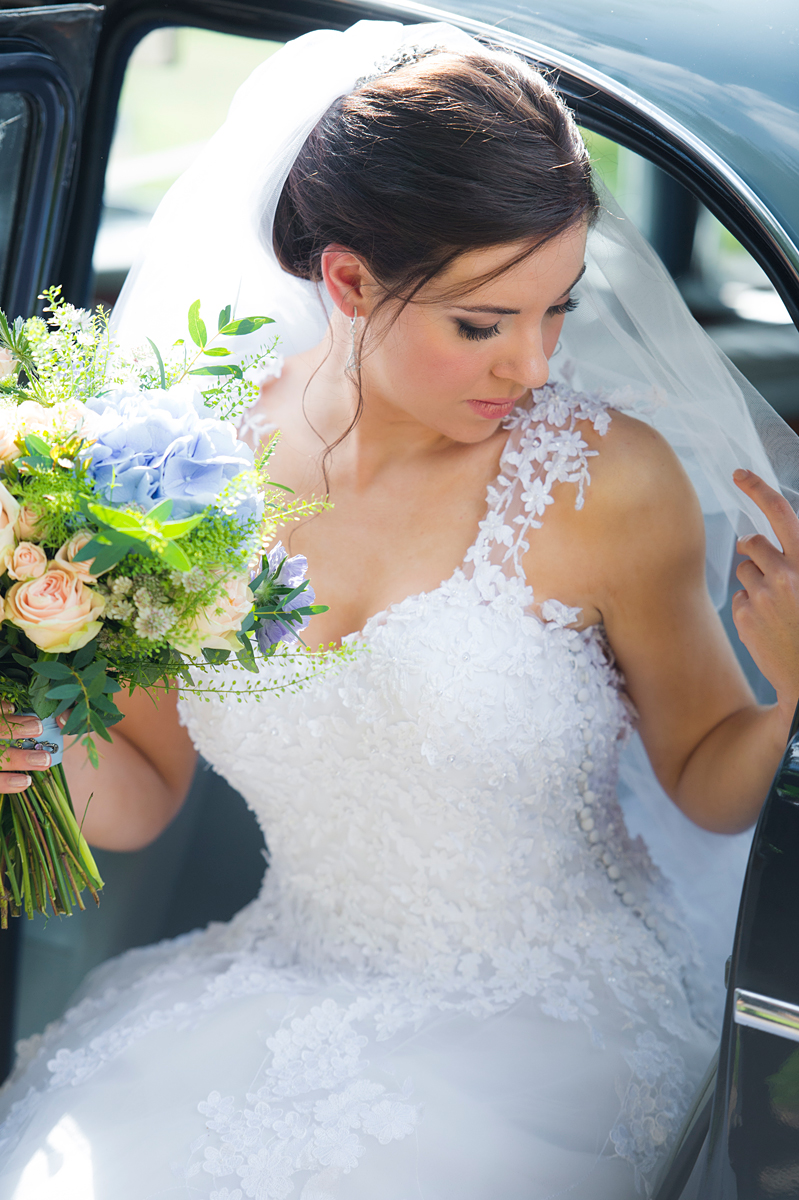 a photograph of a stunning bride as she leaves her car before her wedding