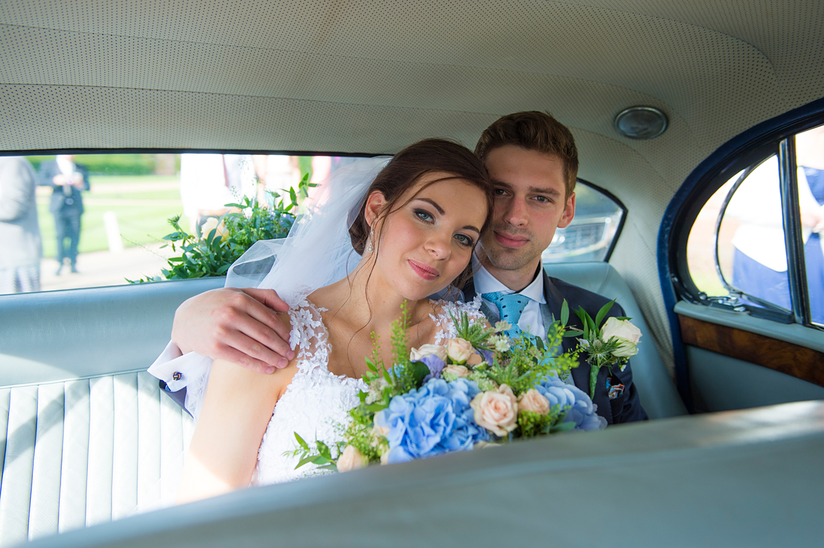 bride and groom in car after ceremony