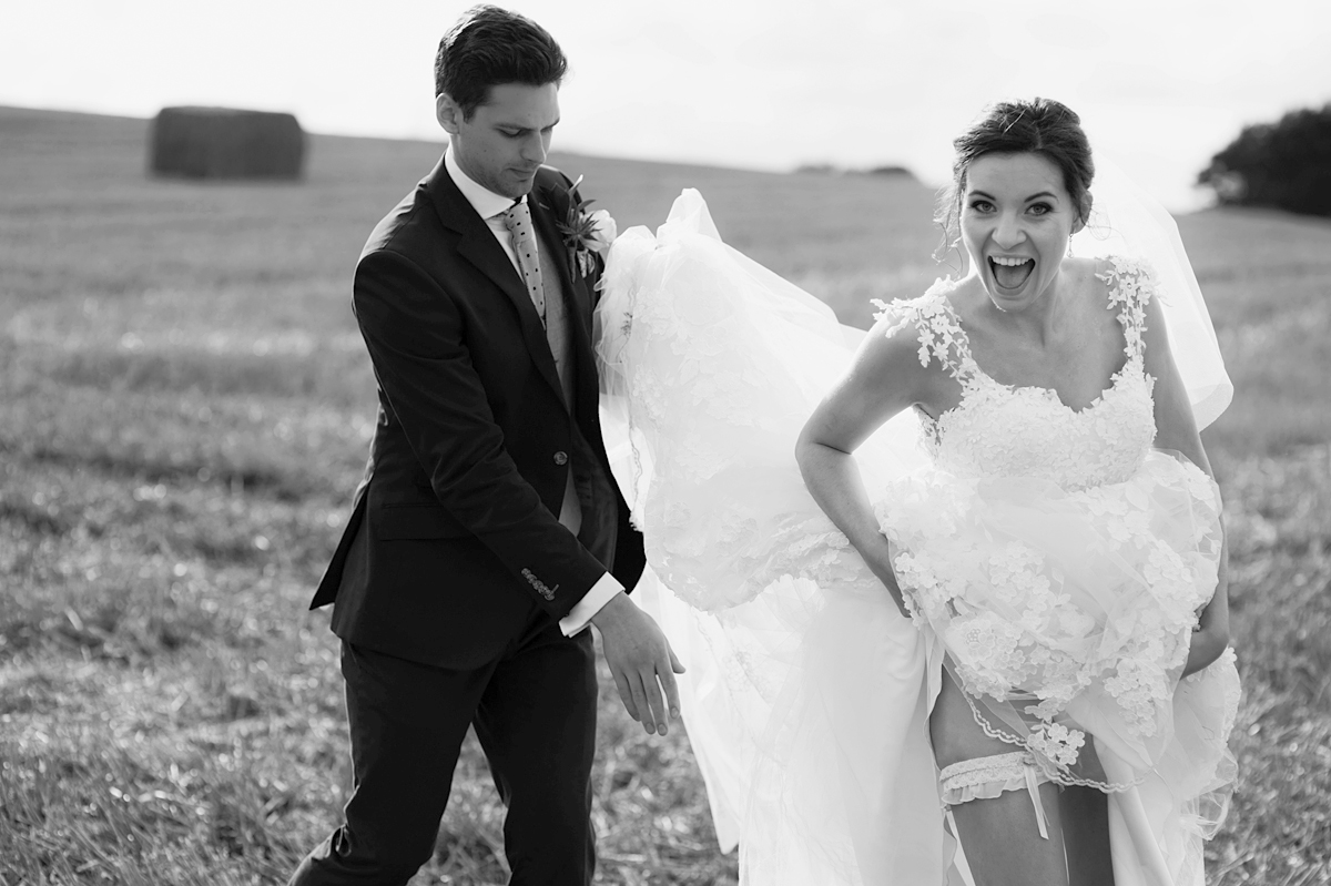 bride reveals garter and bursts into laughter