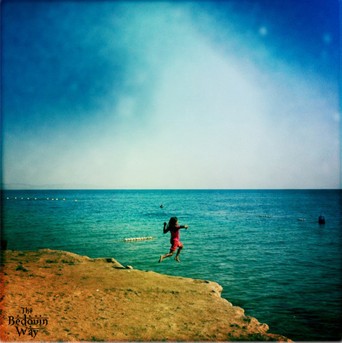 bedouin-girl-jumping-in-sea