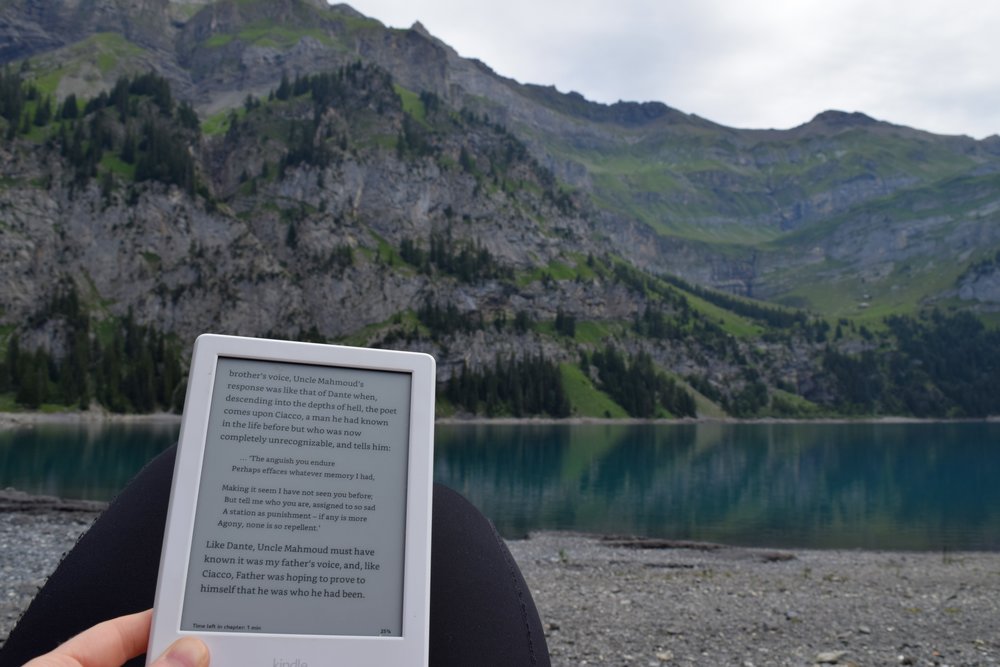  Reading  The Return  by Hisham Matar at 7:55am one drizzly Sunday morning, by the Oeschinensee in the Swiss Alps. 