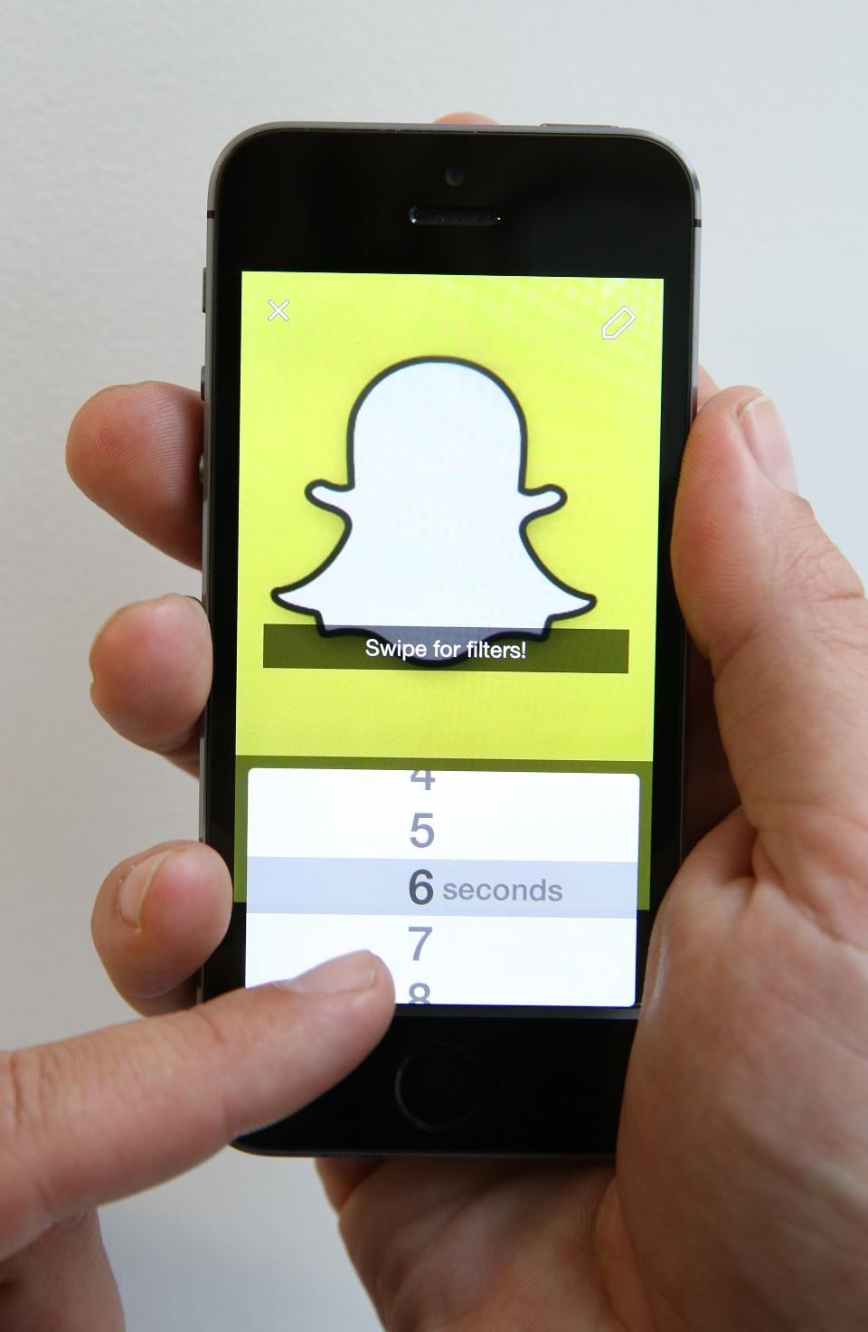 LONDON, ENGLAND – OCTOBER 06: In this photo illustration the Snapchat app is used on an iPhone on October 6, 2014 in London, England. Snapchat allows users’ messages to vanish after seconds. It is being reported that Yahoo may invest millions of dollars in the start up firm. (Photo by Peter Macdiarmid/Getty Images)