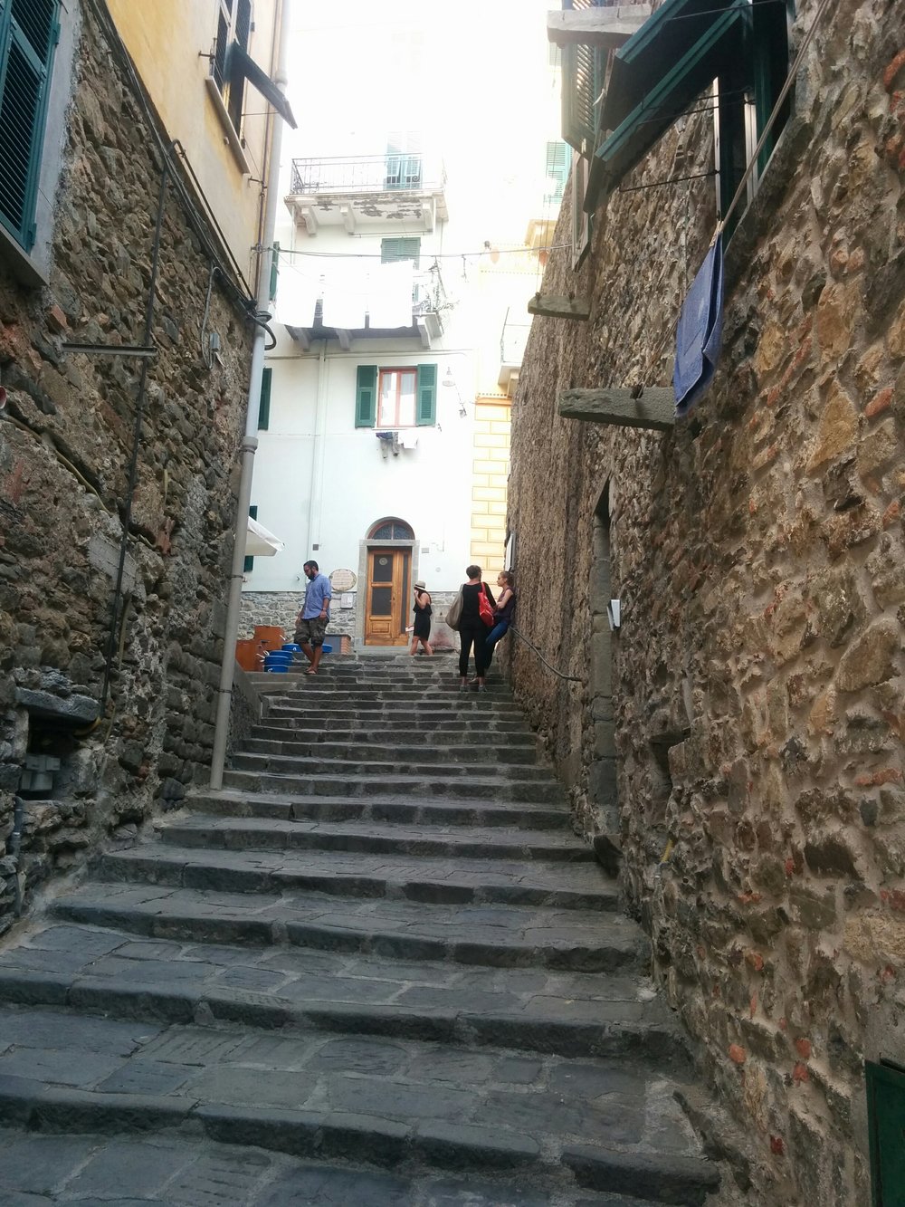  Stairs, stairs, everywhere. These led up to our airbnb. Our room is on the 2nd floor with green shutters and our clean (sink-washed) laundry drying in the wind. 