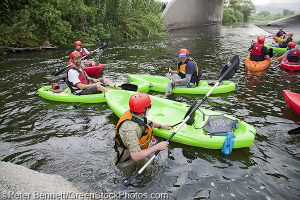 The group waits for one of the boaters to get back in his kayak after a spill in the first rapids.
