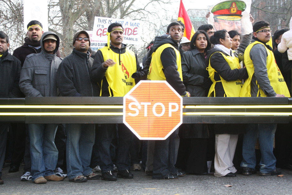 Tamil protestors, London, February 2009. The crush behind the barrier, the emptiness before the barrier, and the 'Stop' sign.