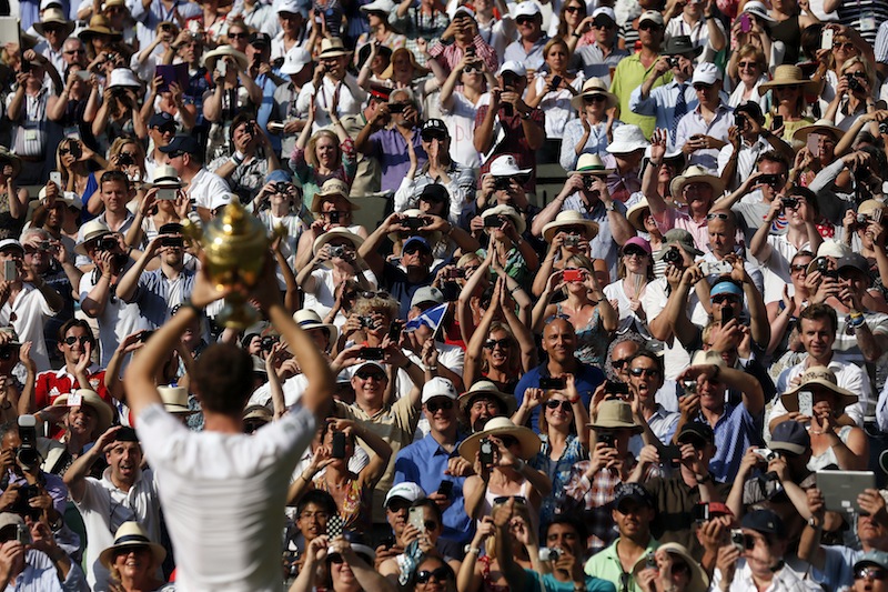 Andy Murray of Great Britain holds the winner’s trophy up to the  spectators after defeating Novak Djokovic of Serbia in the men's  singles final at the Wimbledon Championships.  © Stefan Wermuth / Reuters