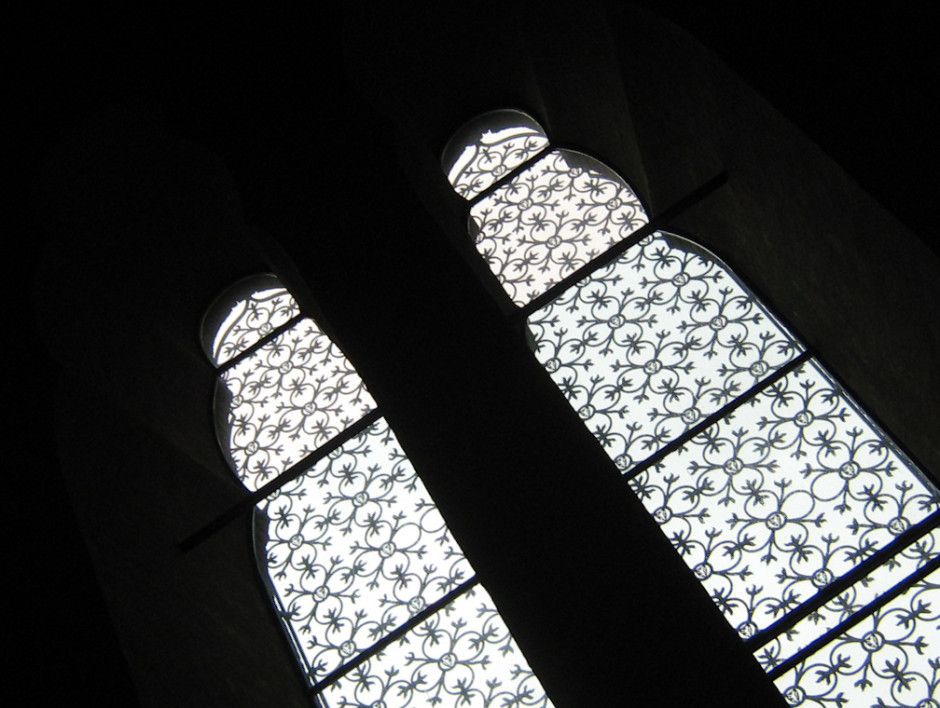 There are two sets of negative space working to create an image here. The black outlines the windows; the light coming through the window highlights the detailing of the latticework. 