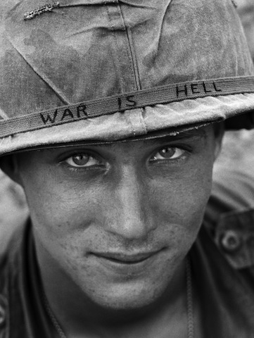 An unidentified American soldier wears a hand-lettered slogan on his helmet, June 1965. The soldier was serving with the 173rd Airborne Brigade on defense duty at the Phuoc Vinh airfield. (AP Photo/Horst Faas)