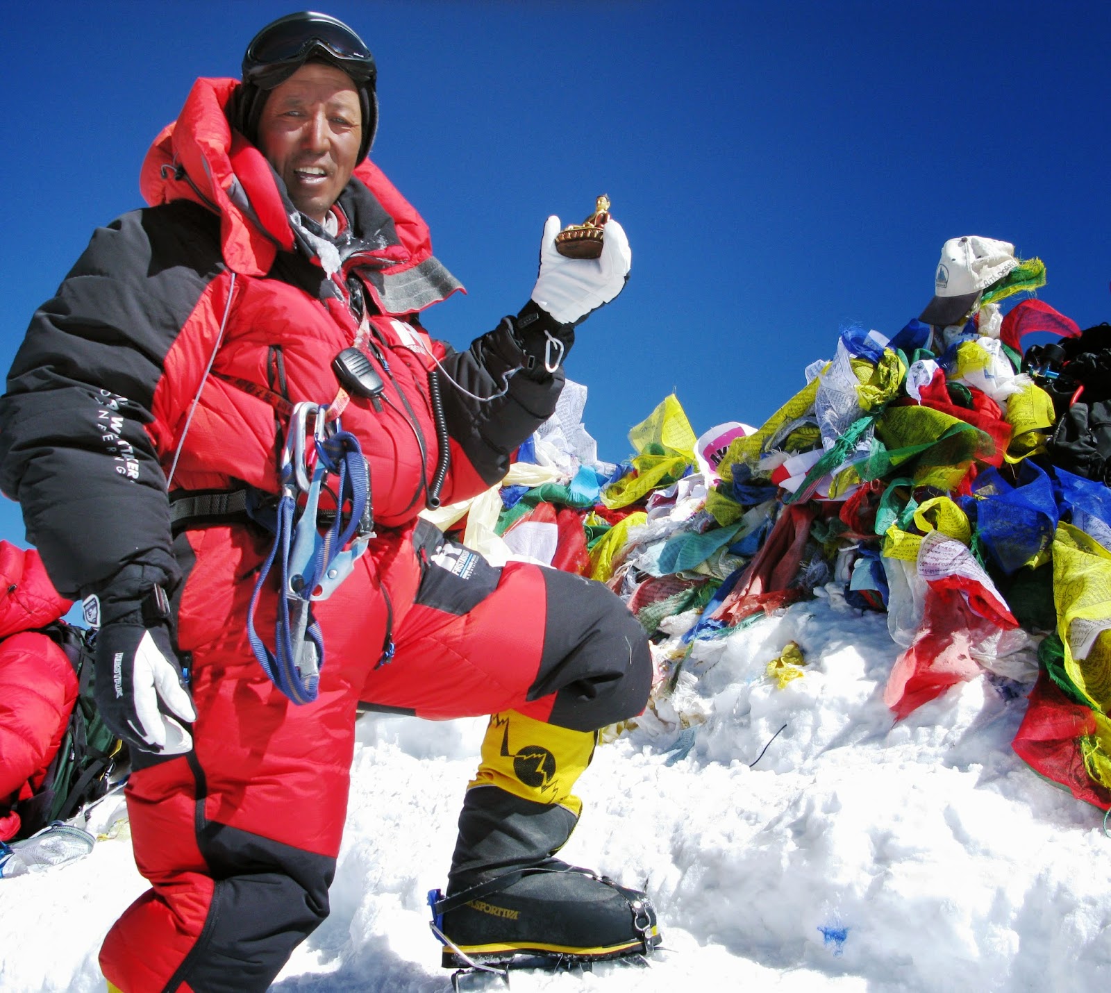 Apa Sherpa on the summit of Everest with a memorial to Sir Edmund Hillary who passed away in 2008. Photo credit: Apa Sherpa Foundation