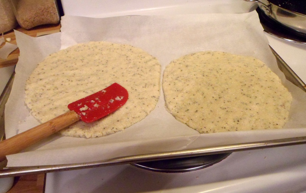Dough spread on a baking sheet lined with parchment paper.