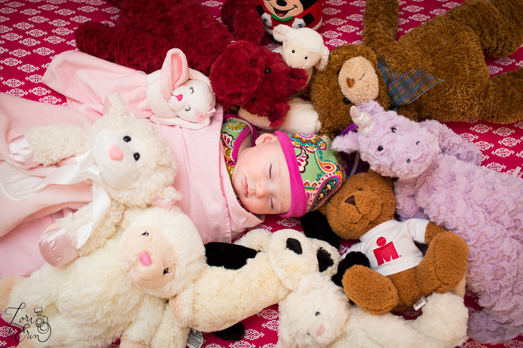 sleeping baby with stuffed animals