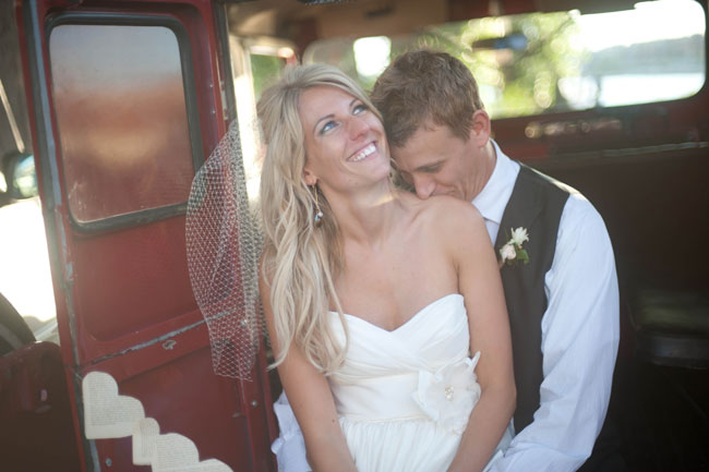Groom Kissing Bride on the shoulder in old truck