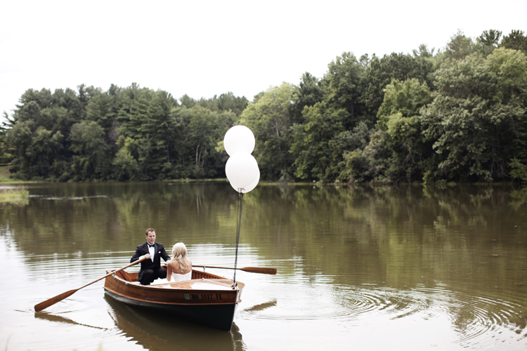 Bride and groom in a boat with ballons