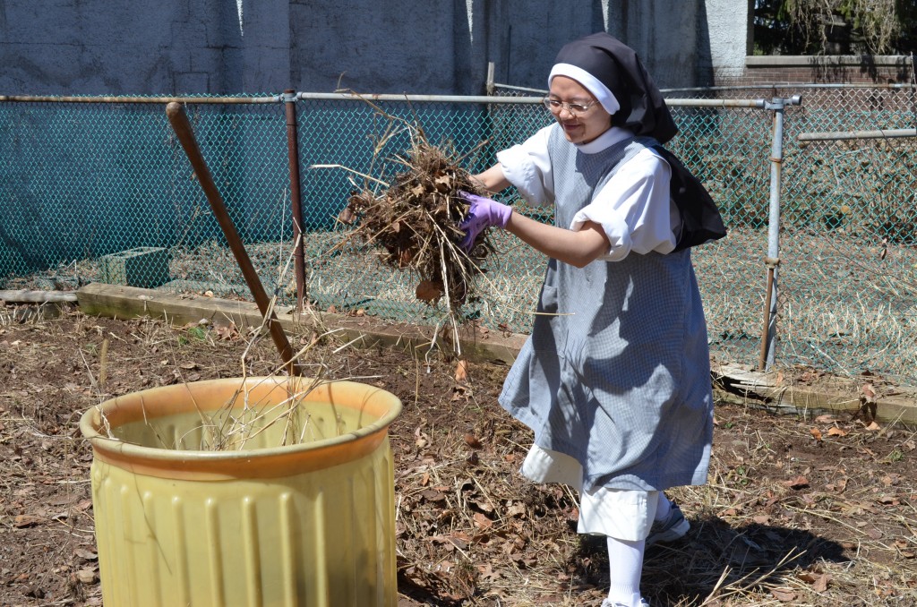 Sr. Joseph Maria clears her garden.