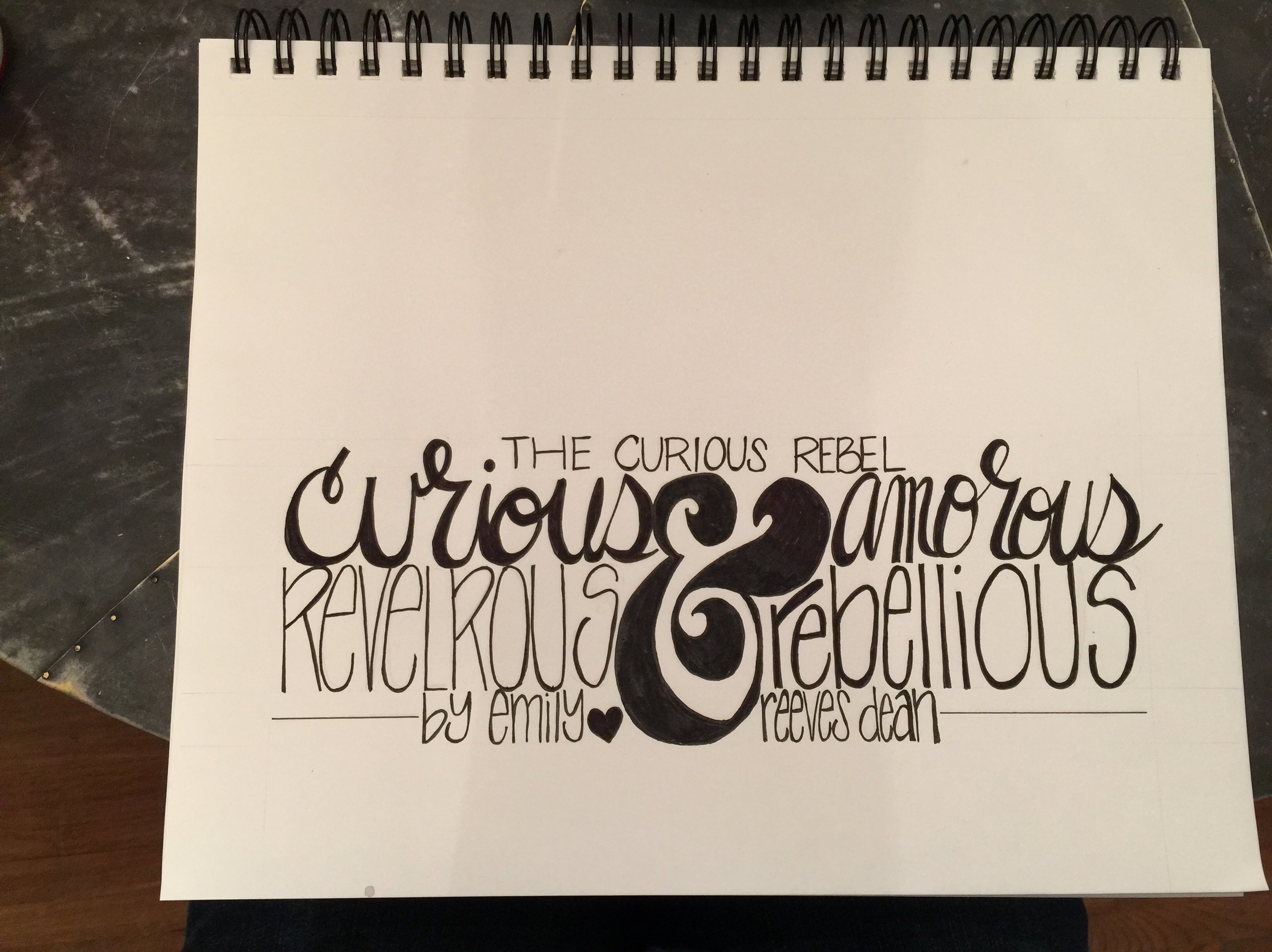 hand lettering by emily reeves that says the curious rebel