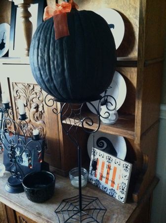 Black pumpkin on stand