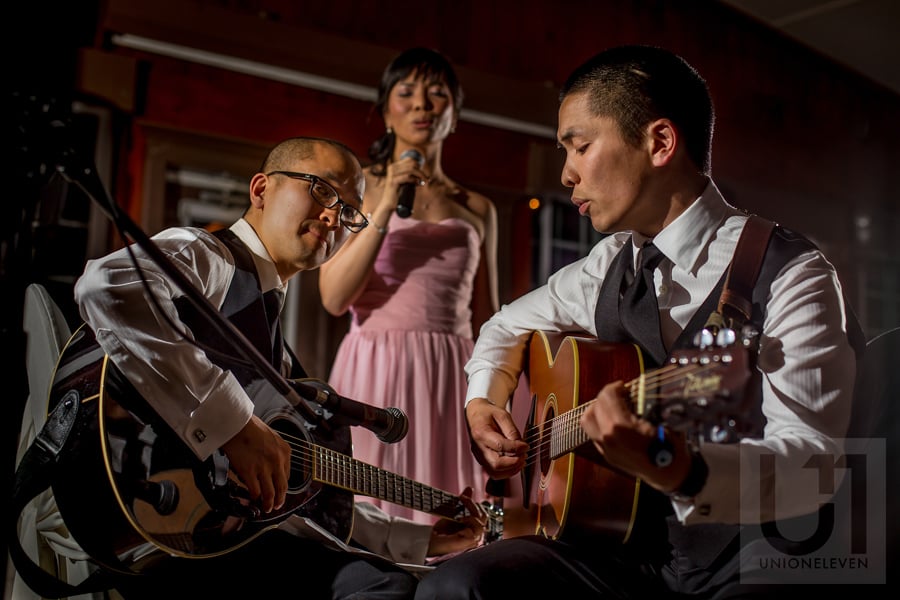 two groomsmen and a bridesmaid playing guitar and  singing during wedding reception at Strathmere