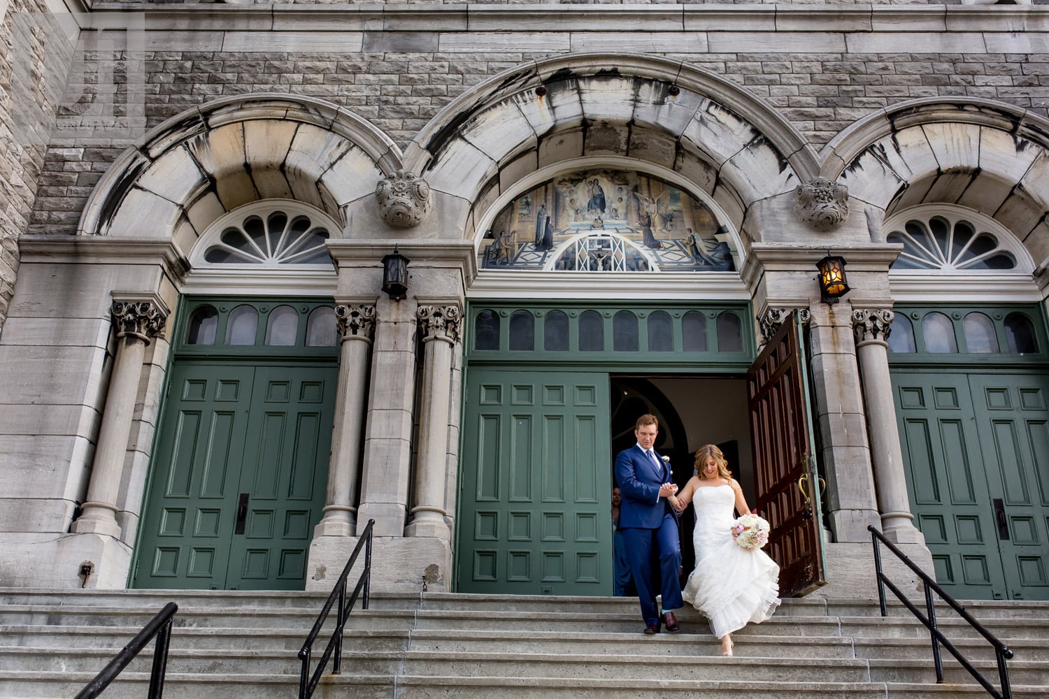 bride and groom exiting Paroisse St-François d'Assise in Ottawa after getting married