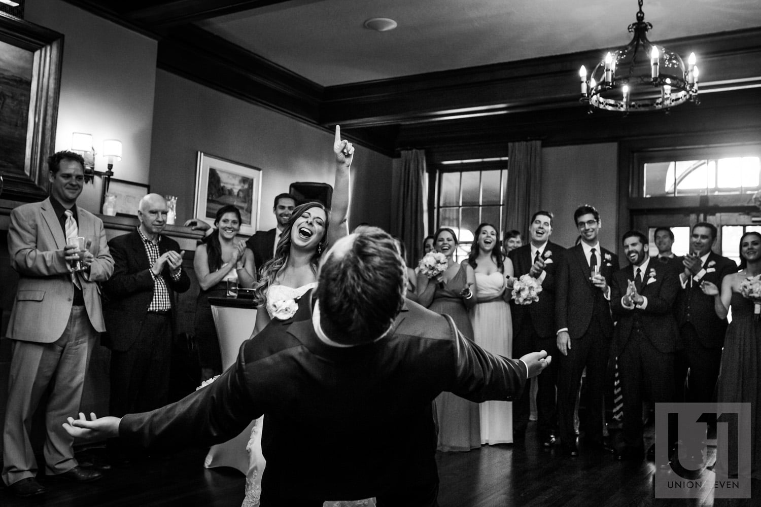 bride dancing with her finger in the air while groom leans backwards on dance floor at wedding reception in Gatineau