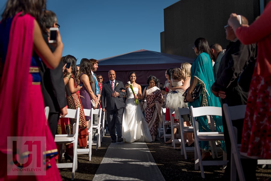 bride being walked down the aisle by her father, during rooftop ceremony at the National Arts Centre in Ottawa