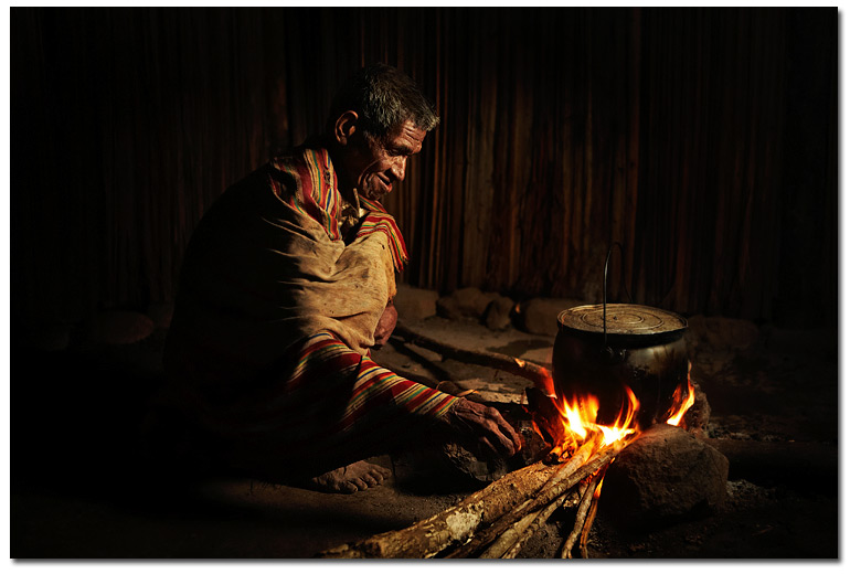 Timorese elder by the fire, taken with the help of a transmitter an off camera flash, a gel and a softbox.