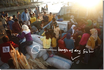 anxious passengers on bags of dry fish