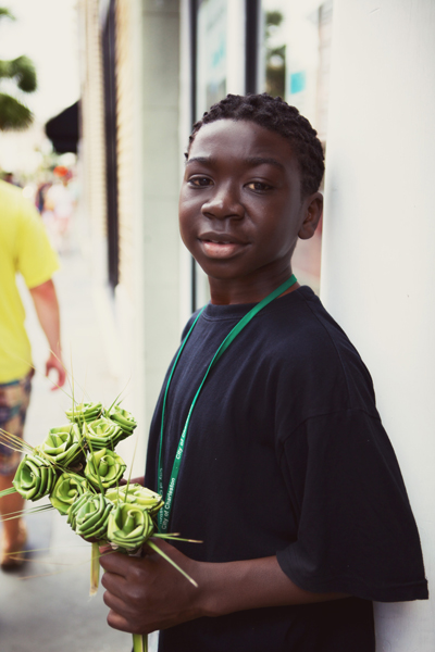 Cute little guy selling flowers on King Street.
