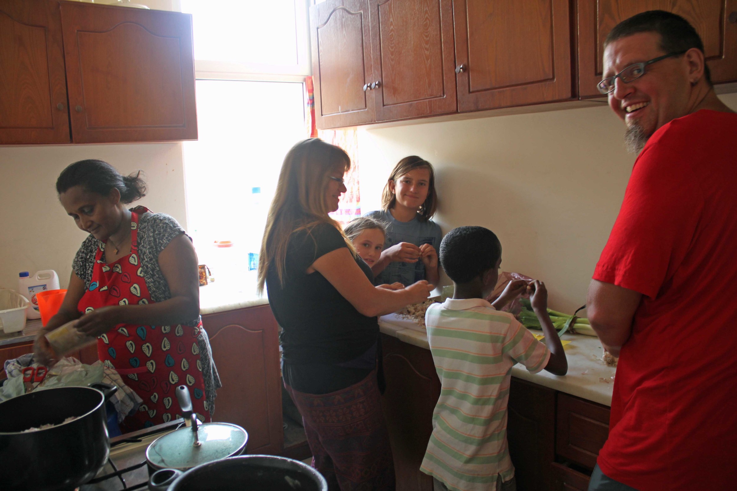 Sebastian and his family learning to cook Ethiopian food. 