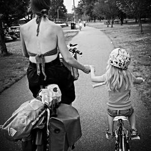 Bikabout-Megan-Ramey-holding-hands-with-daughter-biking