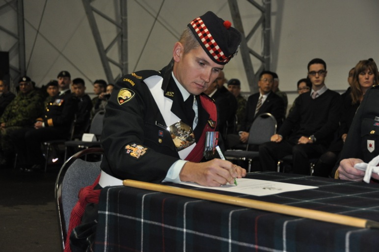 CWO Gormley signing the Change of Appointment scroll