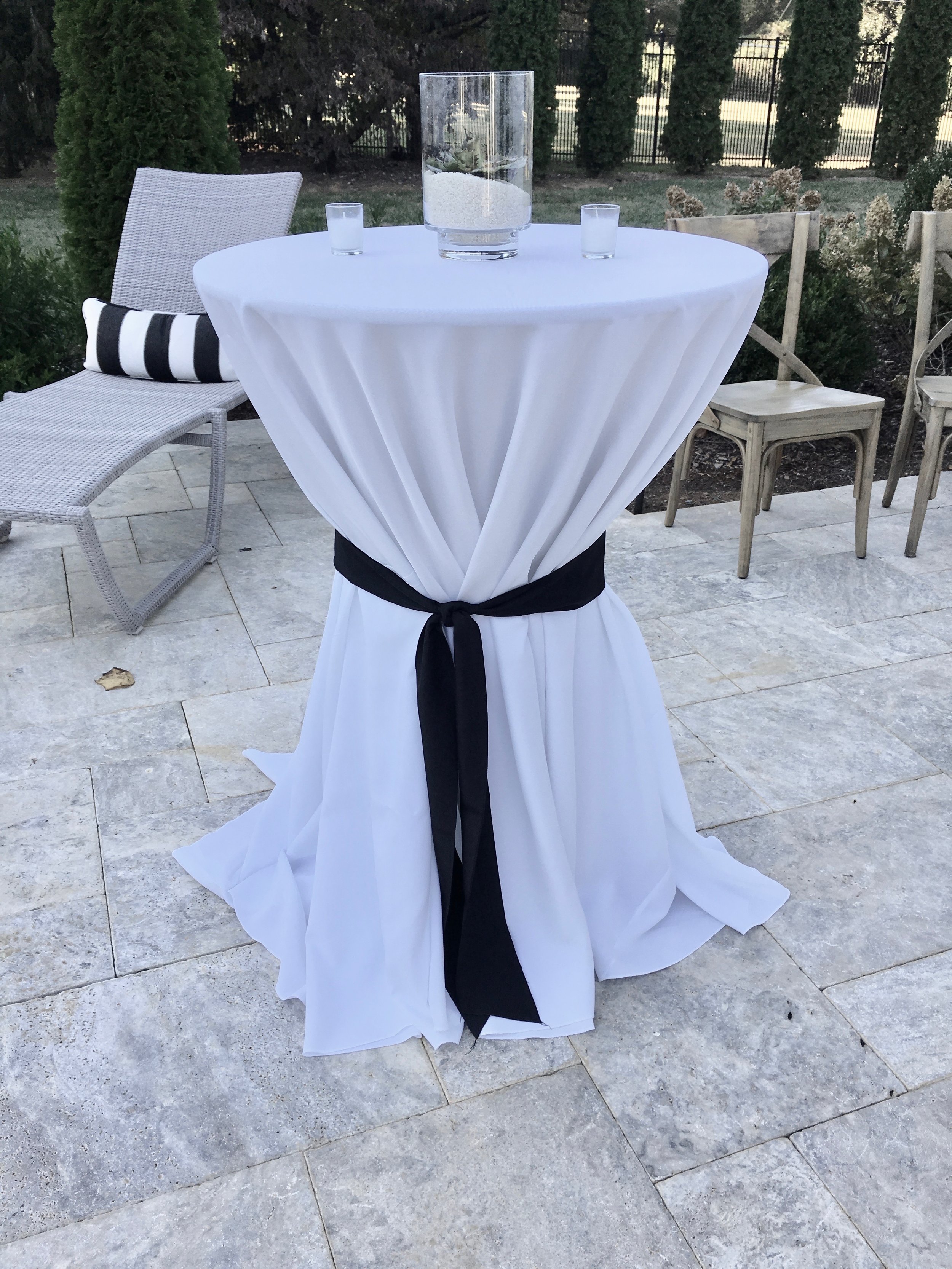  Bar Height Table with White Tablecloth black ribbon and succulent centerpiece 