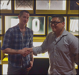 Starbucks' Josh Barrows (left) and Amazon.com's Ben Grace share a hand-shake at MOHAI after being elected to the South Lake Union Community Council.