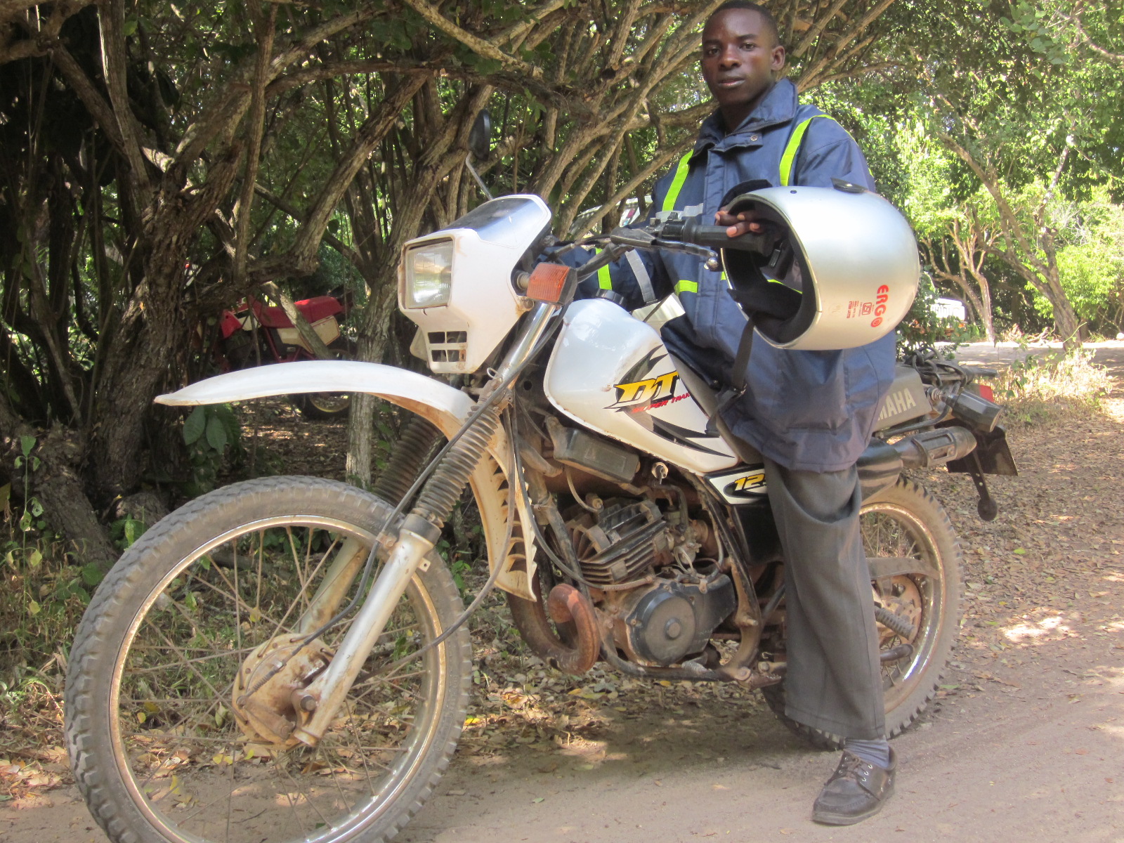 Bimbo, a member of A Rocha's ASSETS team, on his motorcycle dispatching the bursary cheques to the ASSETS students