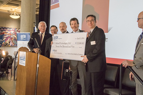 Last year's winners, Redwall Technologies LLC, accept the $25,000 check for winning the Soin Innovation Award.