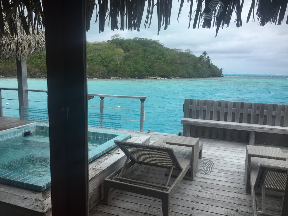 Private deck with a hot tub.  The ladder leads down to a dock where you can jump into the water for snorkeling.   
