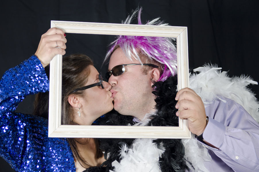 guests kissing at wedding in photobooth at Lago Bar and Grill
